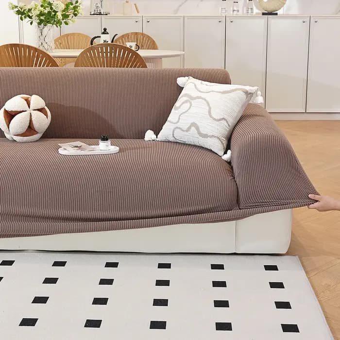Housse de canapé de couleur unie avec bande élastique
