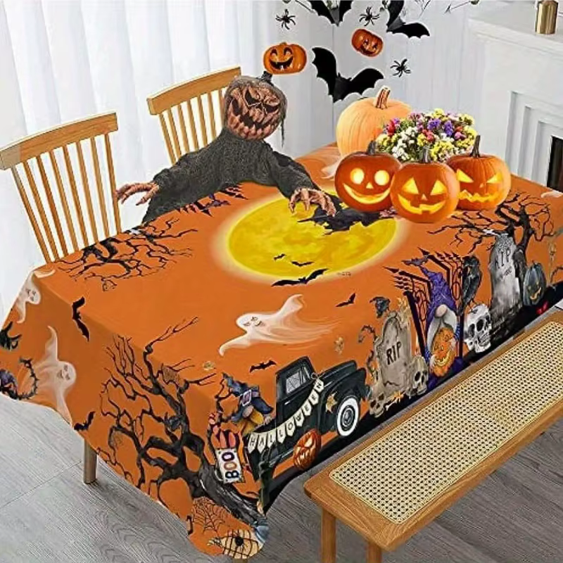 Une nappe rectangulaire sur le thème d'Halloween avec des motifs de camions hantés, d'arbres fantôme
