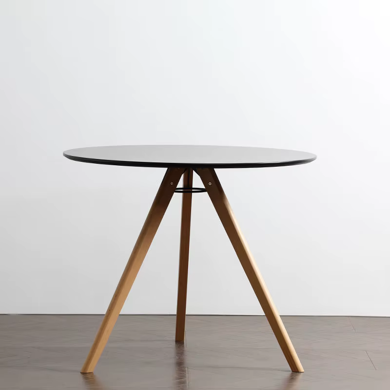 Table à manger ronde élégante avec pieds en bois massif pour les petits espaces, idéale pour la mais